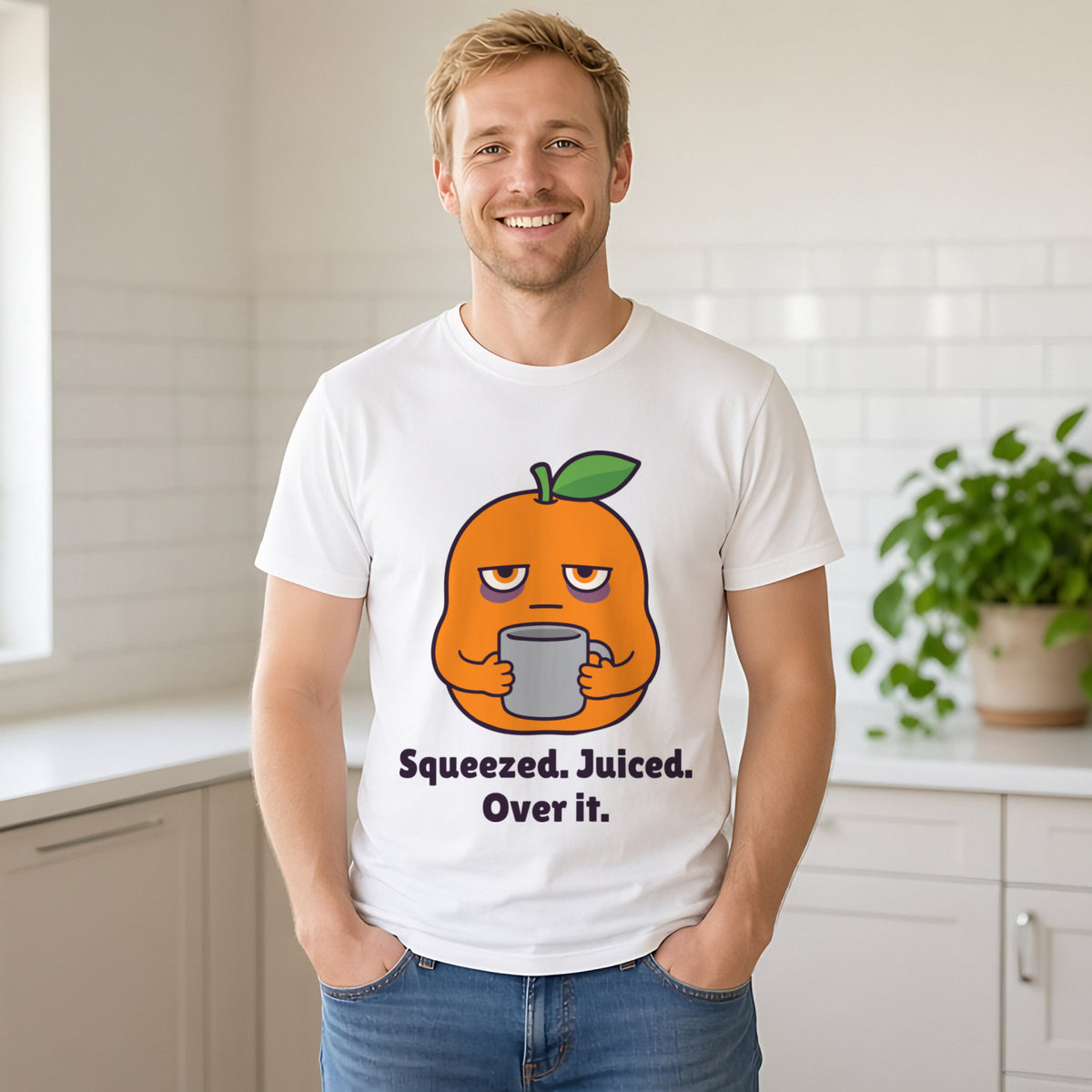 Man with short sandy-blonde hair wearing the white Squeezed Orange tee in a sunny kitchen