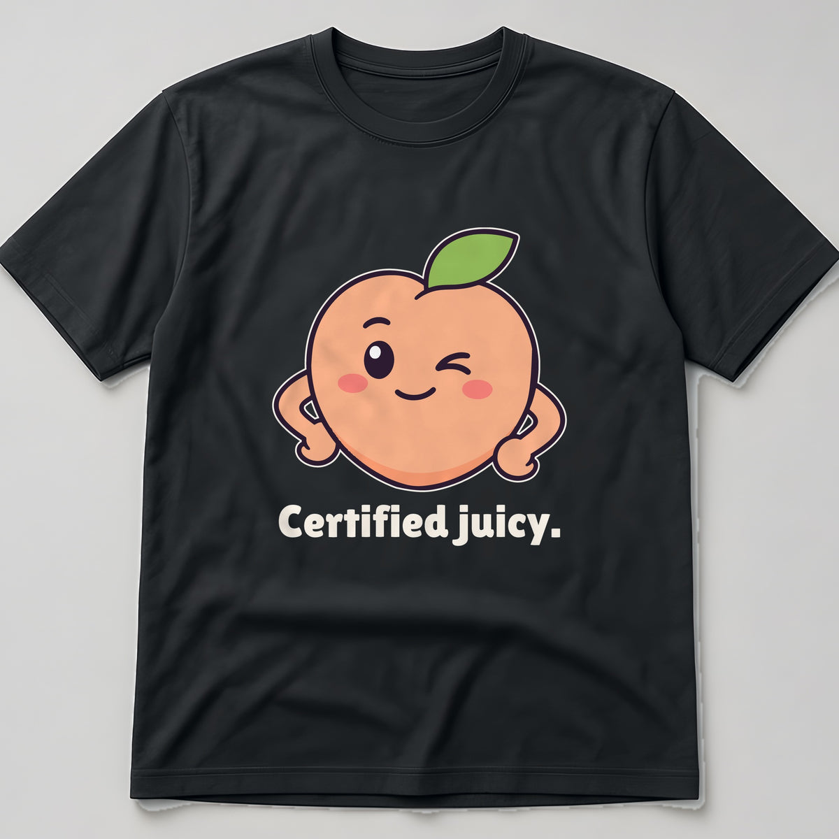 The Winking Peach Tee in black, flat lay