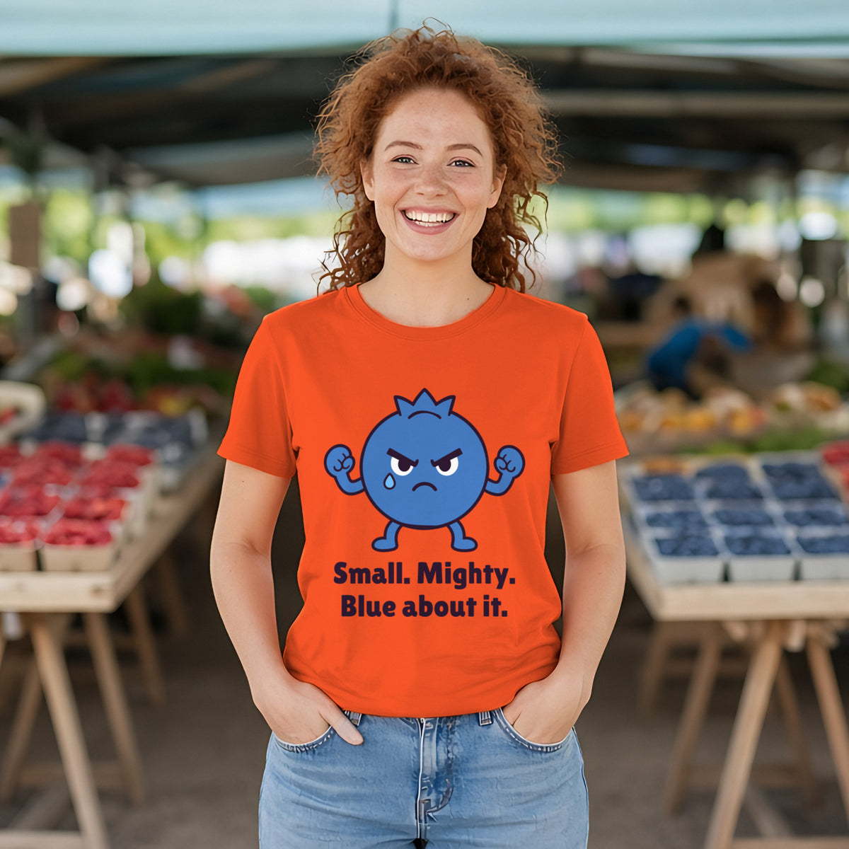 The Tiny Blueberry Tee in orange, worn by a model
