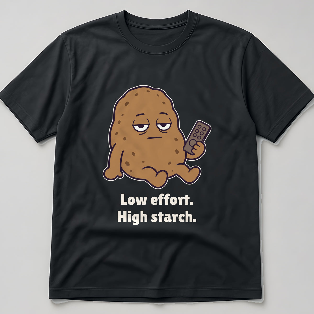 The Low-Effort Potato Tee in black, flat lay