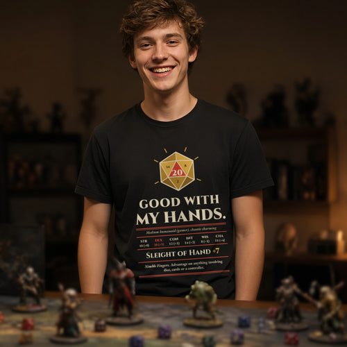 Man wearing a black t-shirt printed with 'Good with my hands. Sleight of Hand +7' (Spicy version), at a tabletop RPG table. Model image is digitally generated. The print shown is the actual design; colours and fit may vary slightly, see size chart.