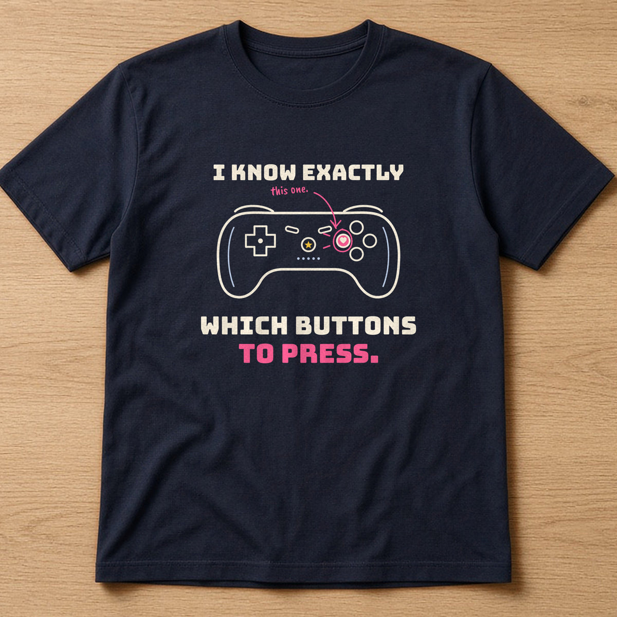 Navy t-shirt, flat lay, printed with 'I know exactly which buttons to press.'