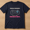 Navy t-shirt, flat lay, printed with the clean version: 'Muscle memory: maxed out.'
