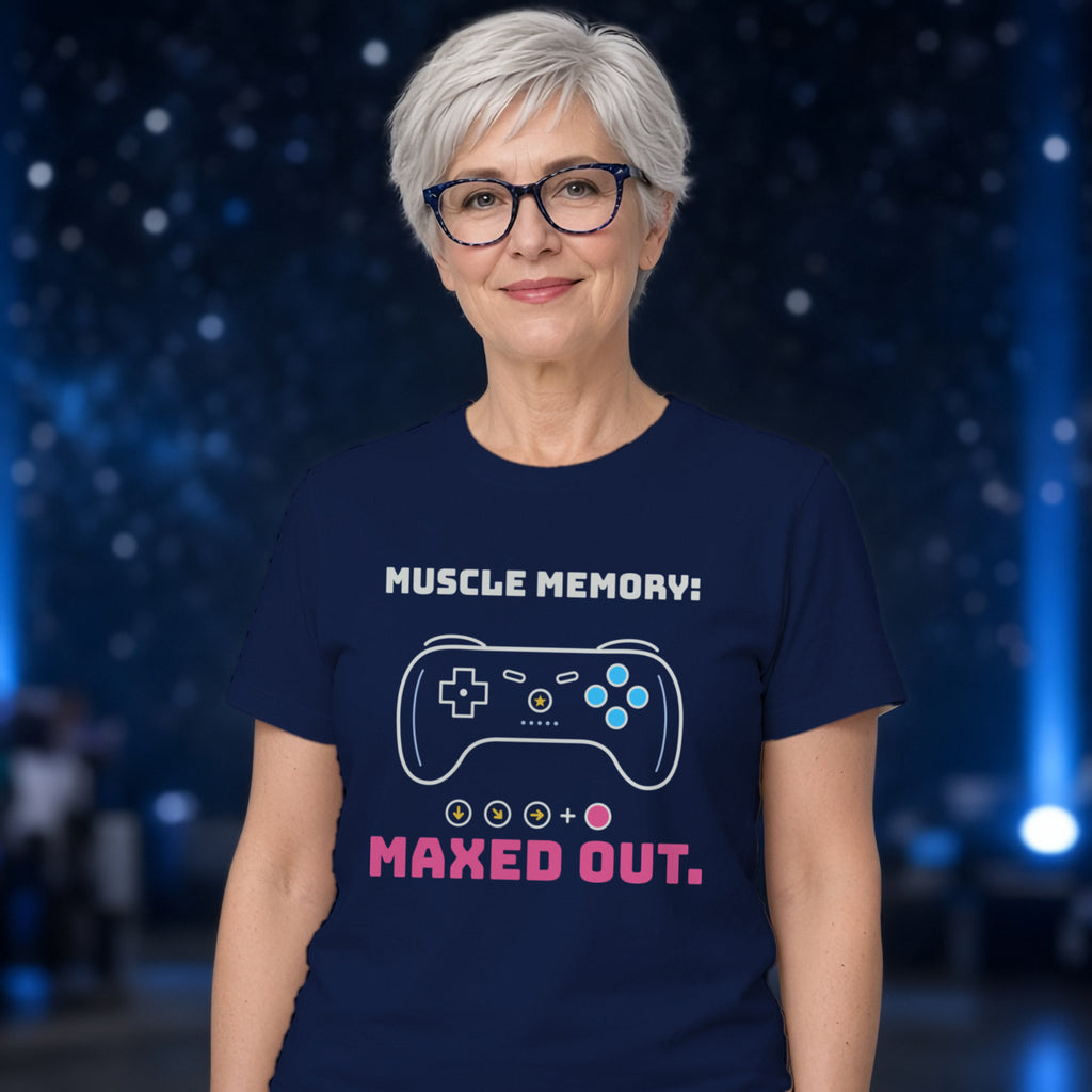 Woman wearing a navy t-shirt printed with 'Muscle memory: maxed out.' (clean version), at a sci-fi convention. Colours and fit may vary slightly, see size chart.