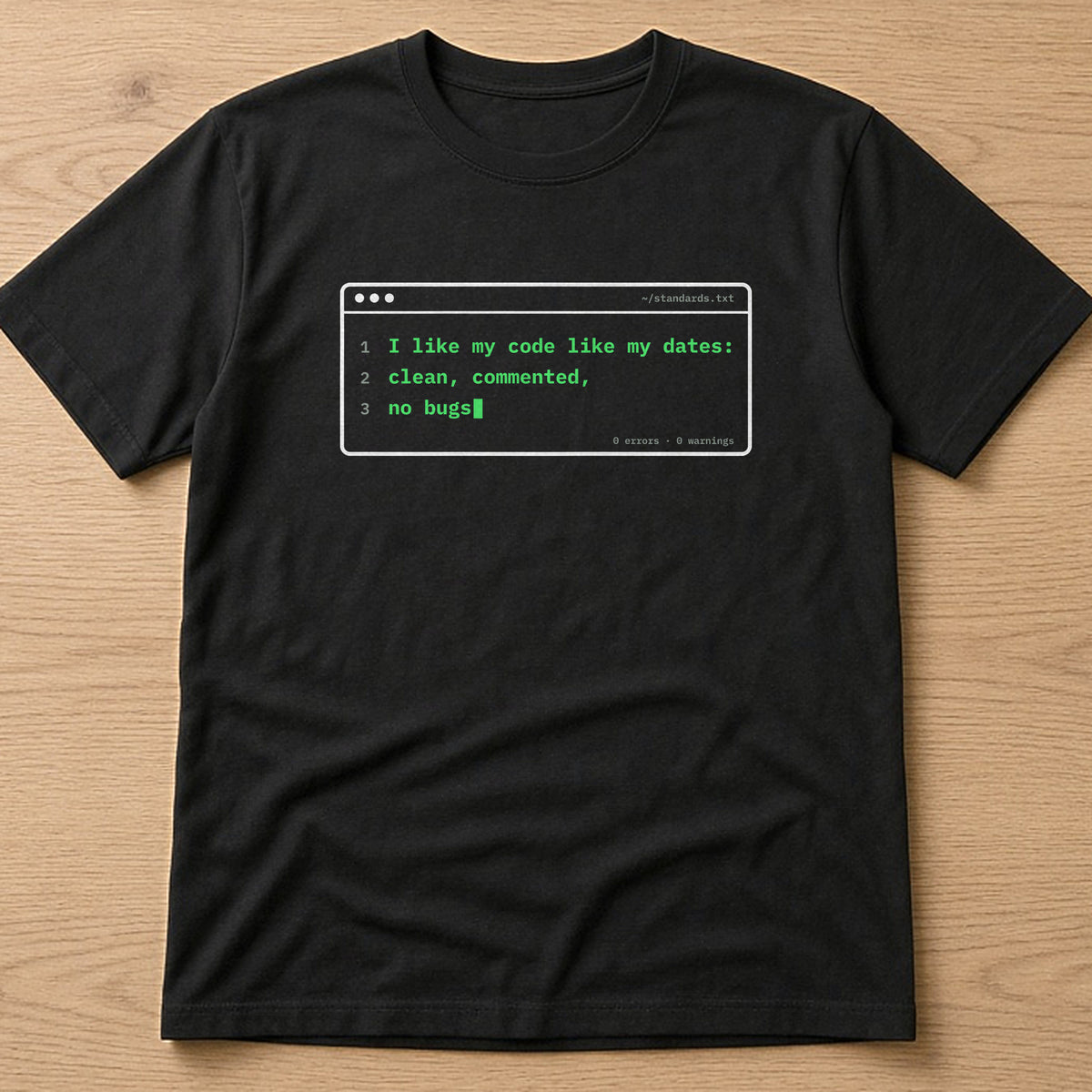 Black t-shirt, flat lay, printed with 'I like my code like my dates: clean, commented, no bugs'