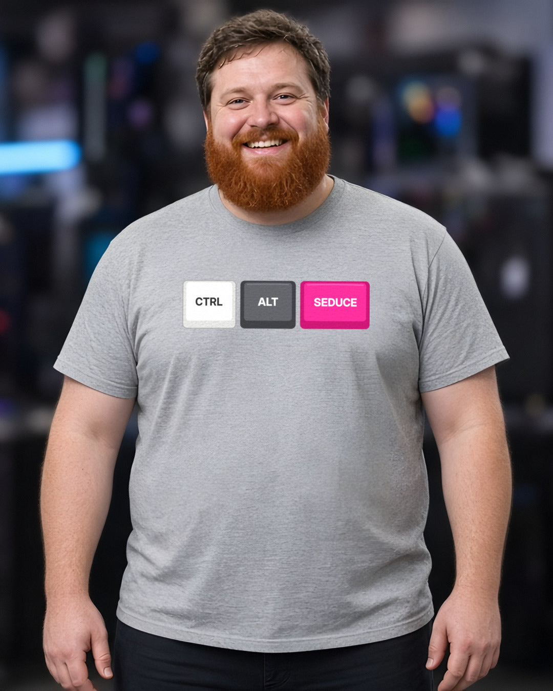 Man wearing a sport grey t-shirt printed with Ctrl Alt Seduce keycaps (Spicy version), at a fan convention (4:5 crop). Colours and fit may vary slightly, see size chart.