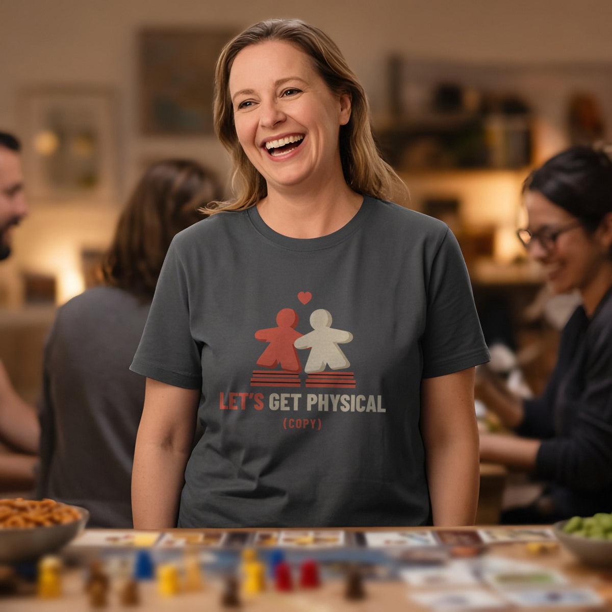 Woman wearing a charcoal t-shirt printed with two meeples sharing a heart (Spicy version), at a board game night. Model image is digitally generated. The print shown is the actual design; colours and fit may vary slightly, see size chart.